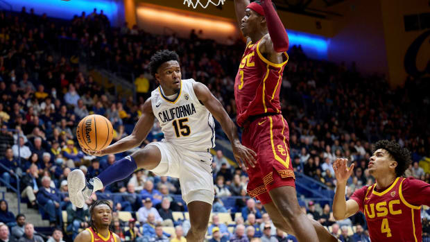 Jalen Cone looks to pass against a USC defender